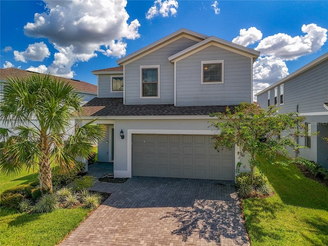 view of front facade with a front lawn and a garage