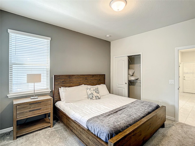 tiled bedroom featuring a closet and multiple windows