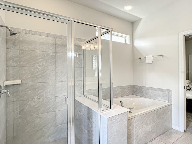 bathroom featuring tile flooring and separate shower and tub