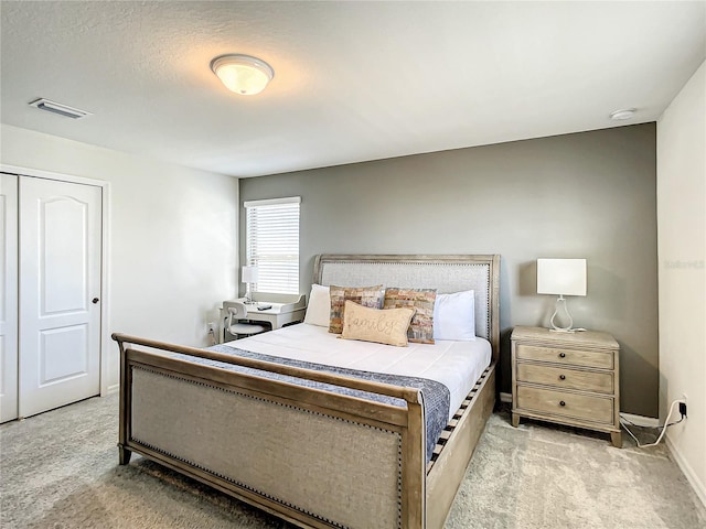 carpeted bedroom with a closet