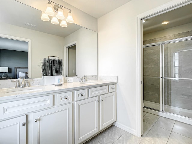 bathroom with a notable chandelier, dual vanity, tile flooring, and a shower with shower door