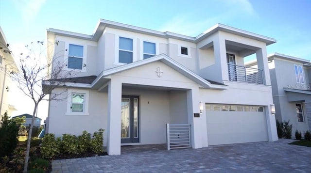 view of front facade with a balcony and a garage