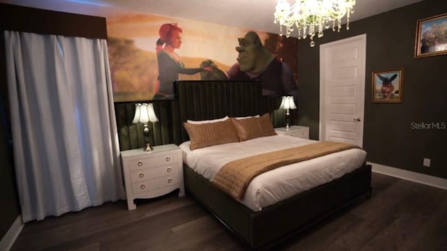 bedroom featuring a chandelier and dark hardwood / wood-style flooring