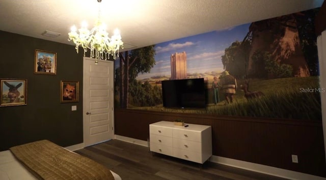 bedroom featuring dark hardwood / wood-style floors and a notable chandelier