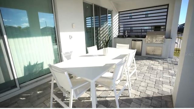 view of patio / terrace with area for grilling and sink