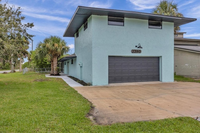 view of home's exterior featuring a garage and a yard