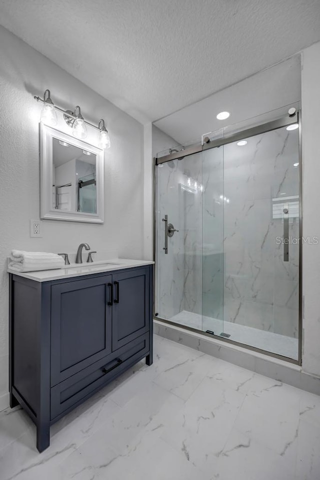 bathroom featuring vanity, tile flooring, a textured ceiling, and a shower with shower door