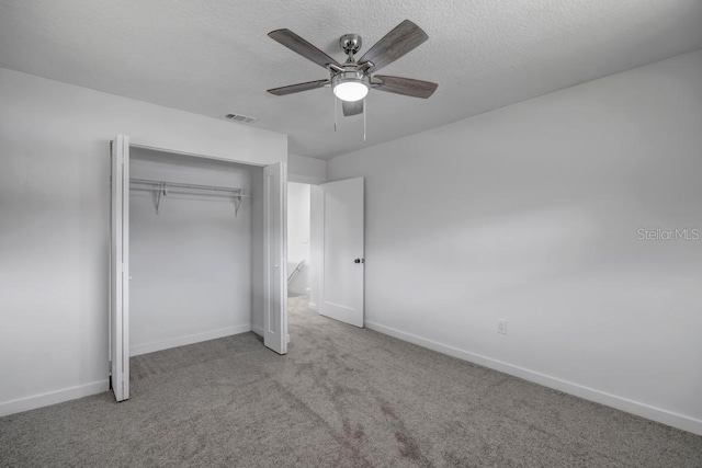 unfurnished bedroom with light carpet, a closet, and ceiling fan