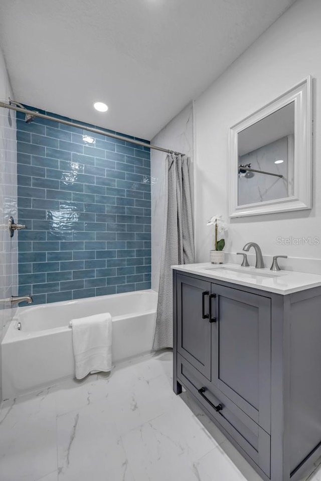 bathroom featuring shower / bath combo with shower curtain, tile floors, and vanity