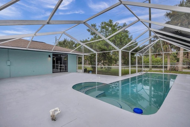 view of swimming pool featuring a patio area and a lanai