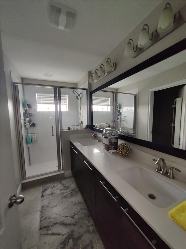 bathroom featuring double vanity, tile flooring, and walk in shower