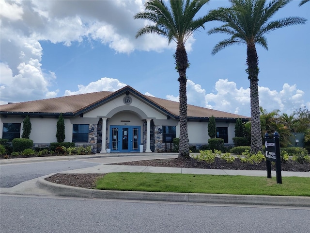 mediterranean / spanish-style home with french doors