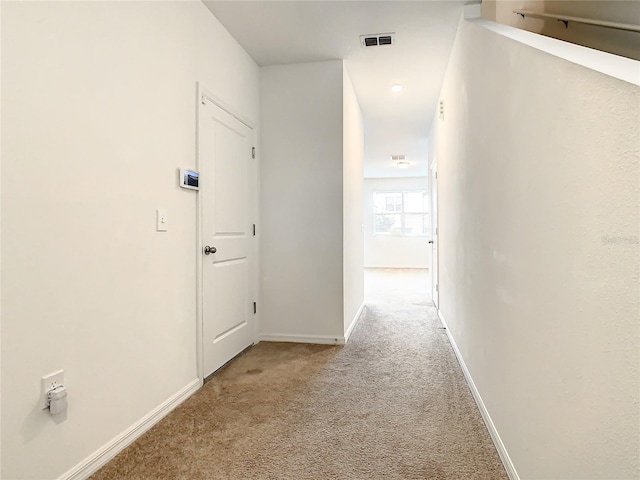 hallway featuring light carpet