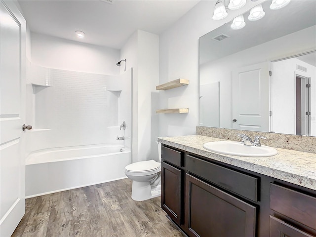 full bathroom with oversized vanity, hardwood / wood-style floors, shower / bathing tub combination, and toilet