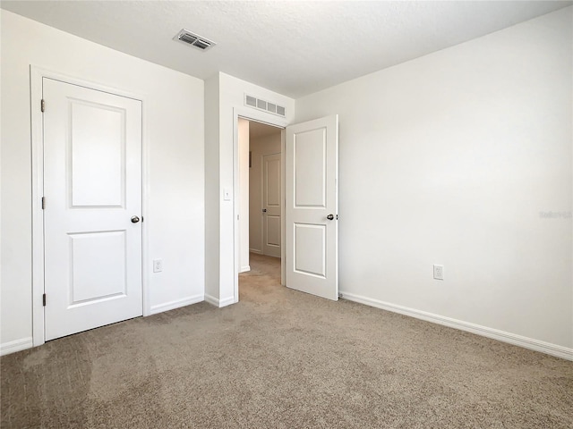 unfurnished bedroom with light colored carpet