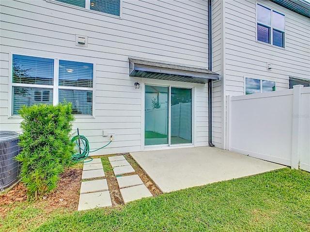 rear view of property with a yard, a patio, and central AC unit