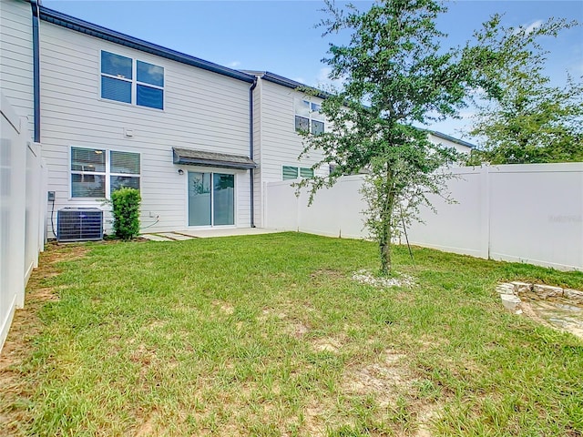 exterior space featuring a lawn and central AC unit