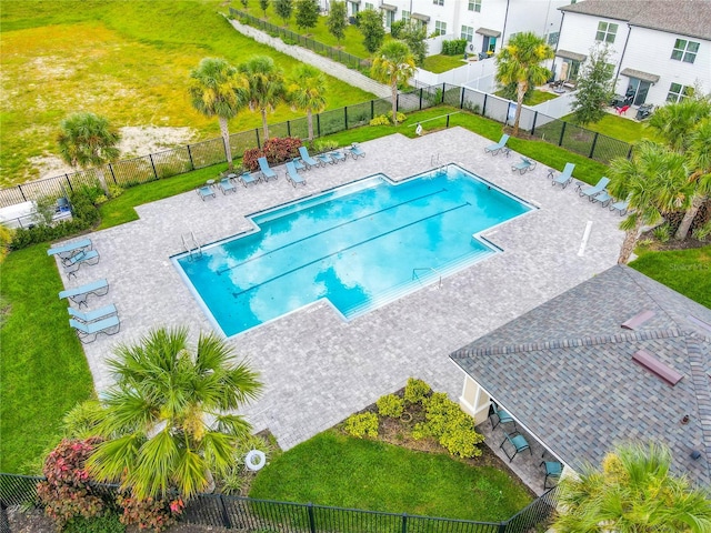 view of swimming pool featuring a yard and a patio area