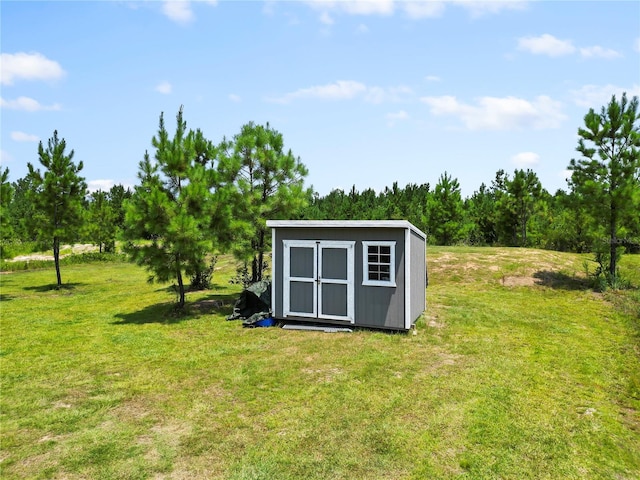 view of outbuilding featuring a yard