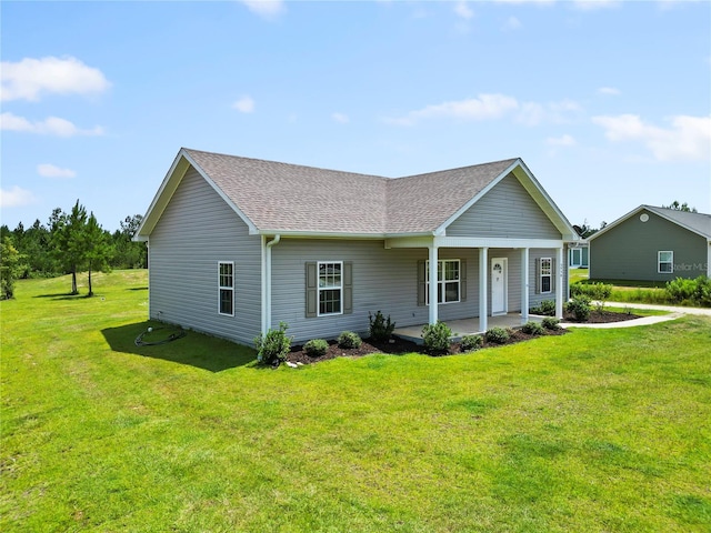 ranch-style house with covered porch and a front yard