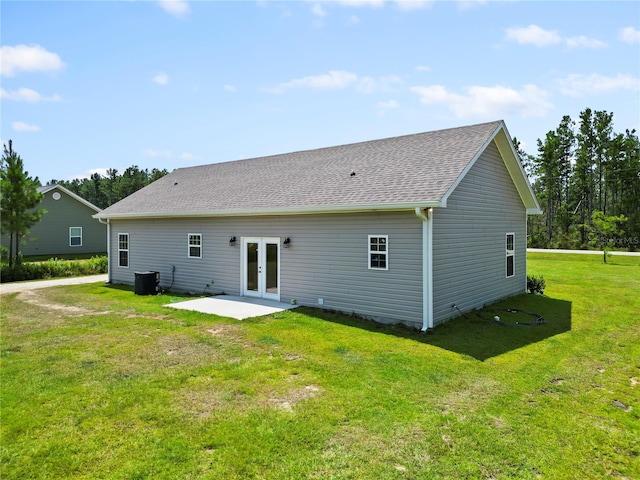 back of property featuring french doors, a patio, central AC, and a lawn