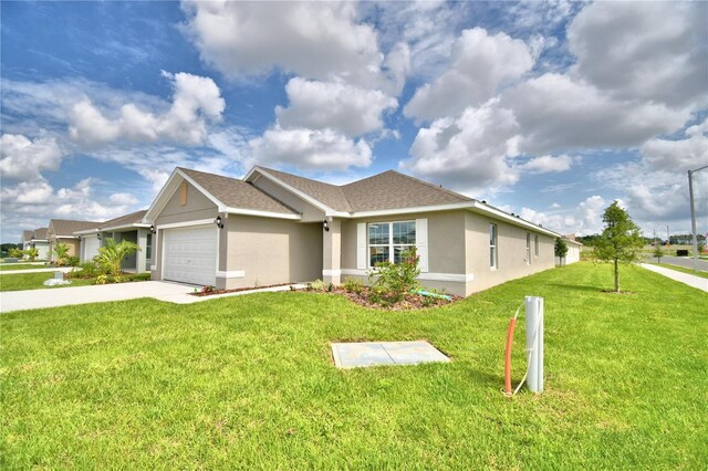 single story home featuring a front lawn and a garage