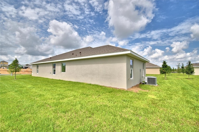 exterior space with a yard and central air condition unit