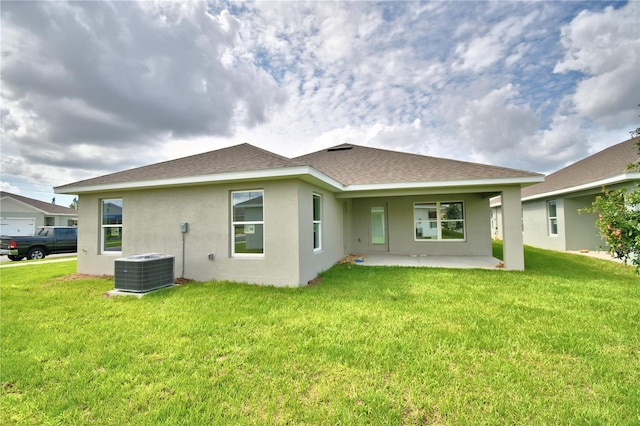 back of house with a yard, central air condition unit, and a patio area