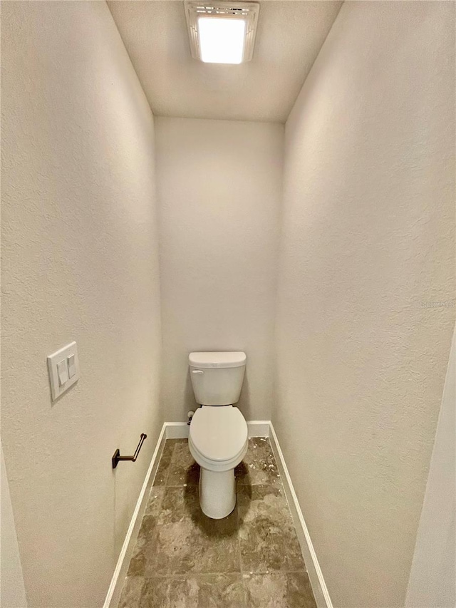 bathroom with toilet and tile flooring