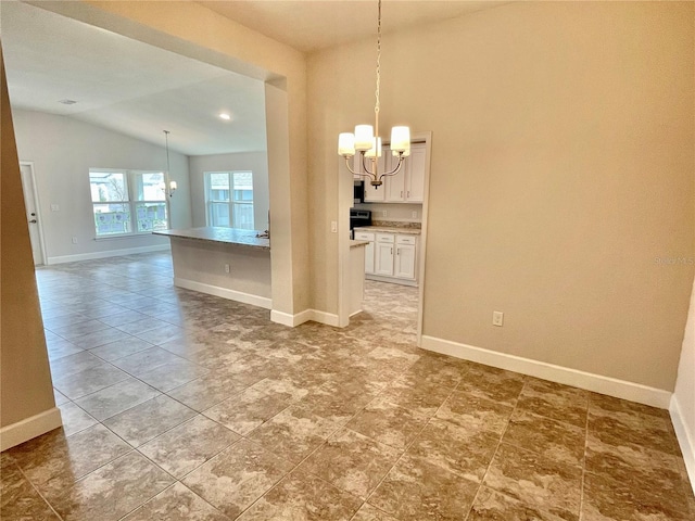 unfurnished dining area with a notable chandelier, vaulted ceiling, and light tile floors