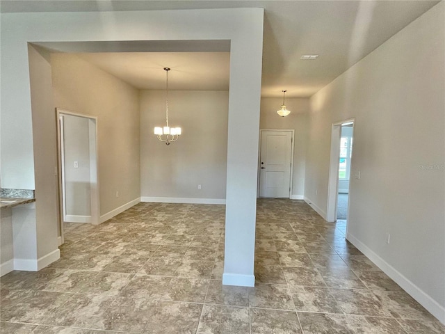 unfurnished room with an inviting chandelier and light tile flooring