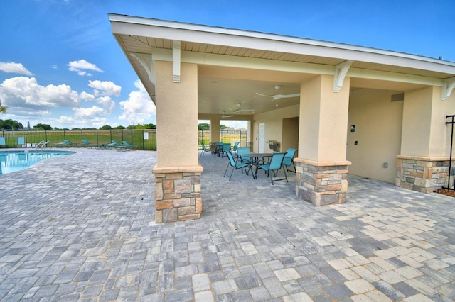 view of terrace with a community pool and ceiling fan