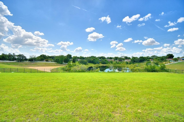 view of yard with a rural view and a water view