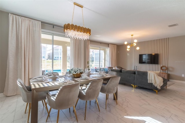 dining room featuring a notable chandelier, plenty of natural light, and light tile flooring