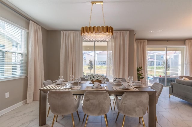 dining space featuring a chandelier and light tile floors