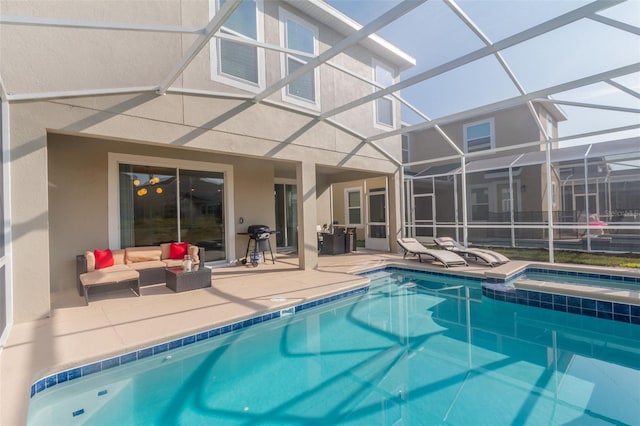 view of swimming pool with an in ground hot tub, glass enclosure, and a patio