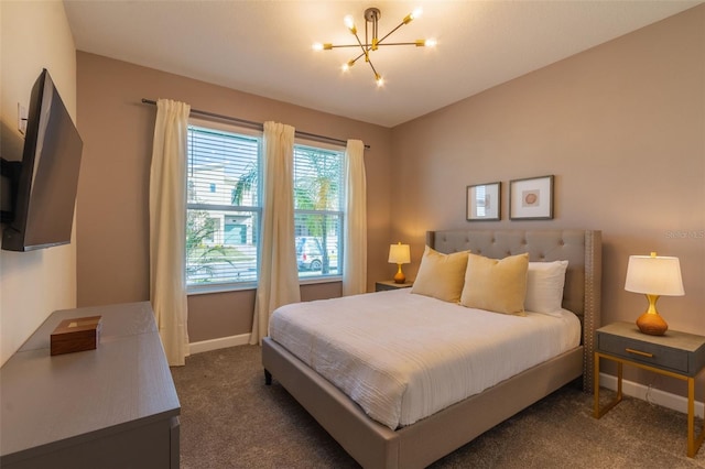 bedroom featuring a notable chandelier and dark carpet