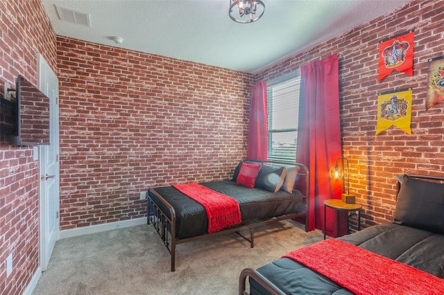 bedroom with brick wall, a textured ceiling, and light carpet