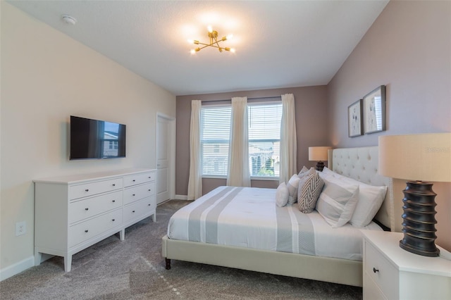 carpeted bedroom featuring a notable chandelier