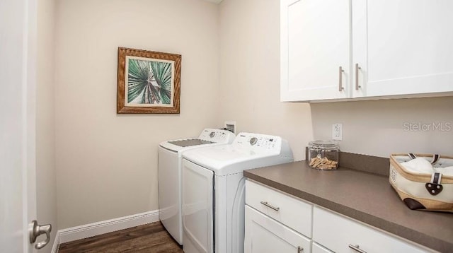 clothes washing area featuring cabinets, dark hardwood / wood-style flooring, and washing machine and dryer