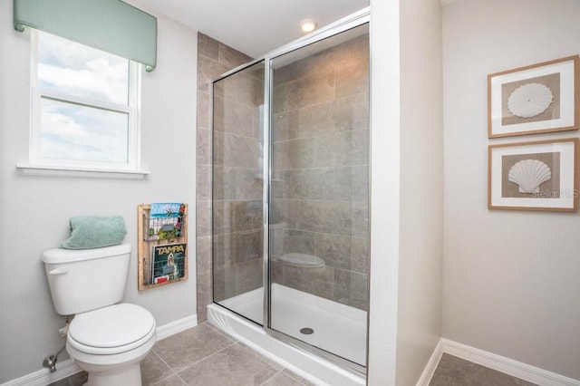 bathroom featuring an enclosed shower, tile patterned floors, and toilet