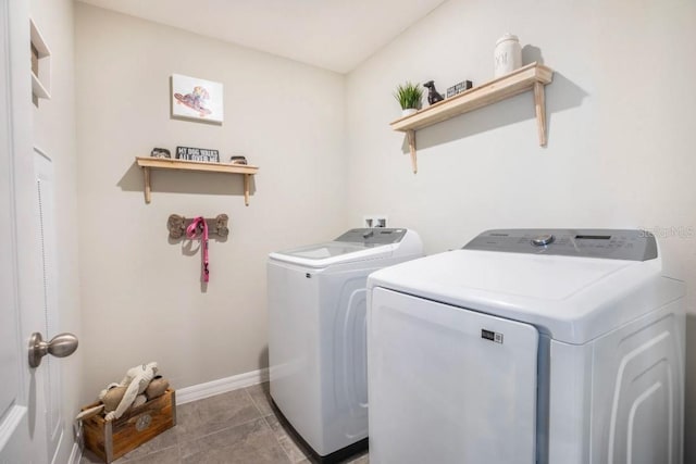 laundry room with light tile patterned flooring and washing machine and clothes dryer