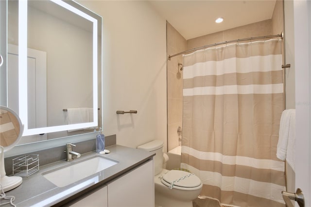 full bathroom with toilet, shower / tub combo with curtain, and large vanity