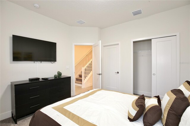 carpeted bedroom featuring a closet