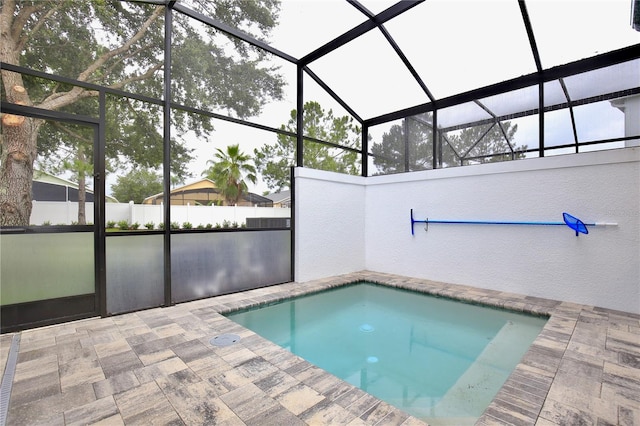 view of swimming pool with a lanai and a patio area