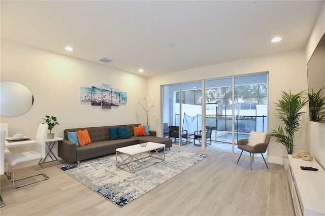 living room featuring light hardwood / wood-style floors and a baseboard radiator