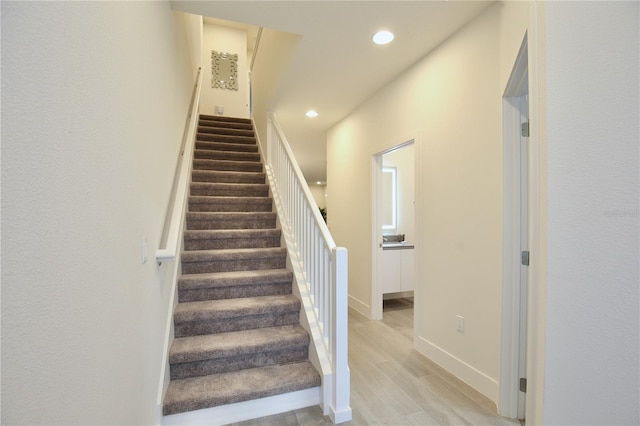 staircase with light hardwood / wood-style flooring