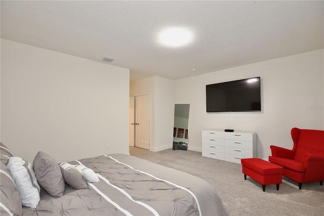 carpeted bedroom featuring a textured ceiling