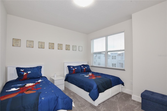 carpeted bedroom featuring a textured ceiling