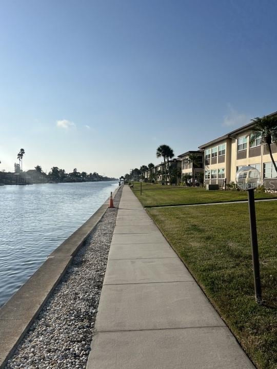 dock area featuring a yard and a water view